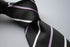 black tie with  thin purple and white stripes